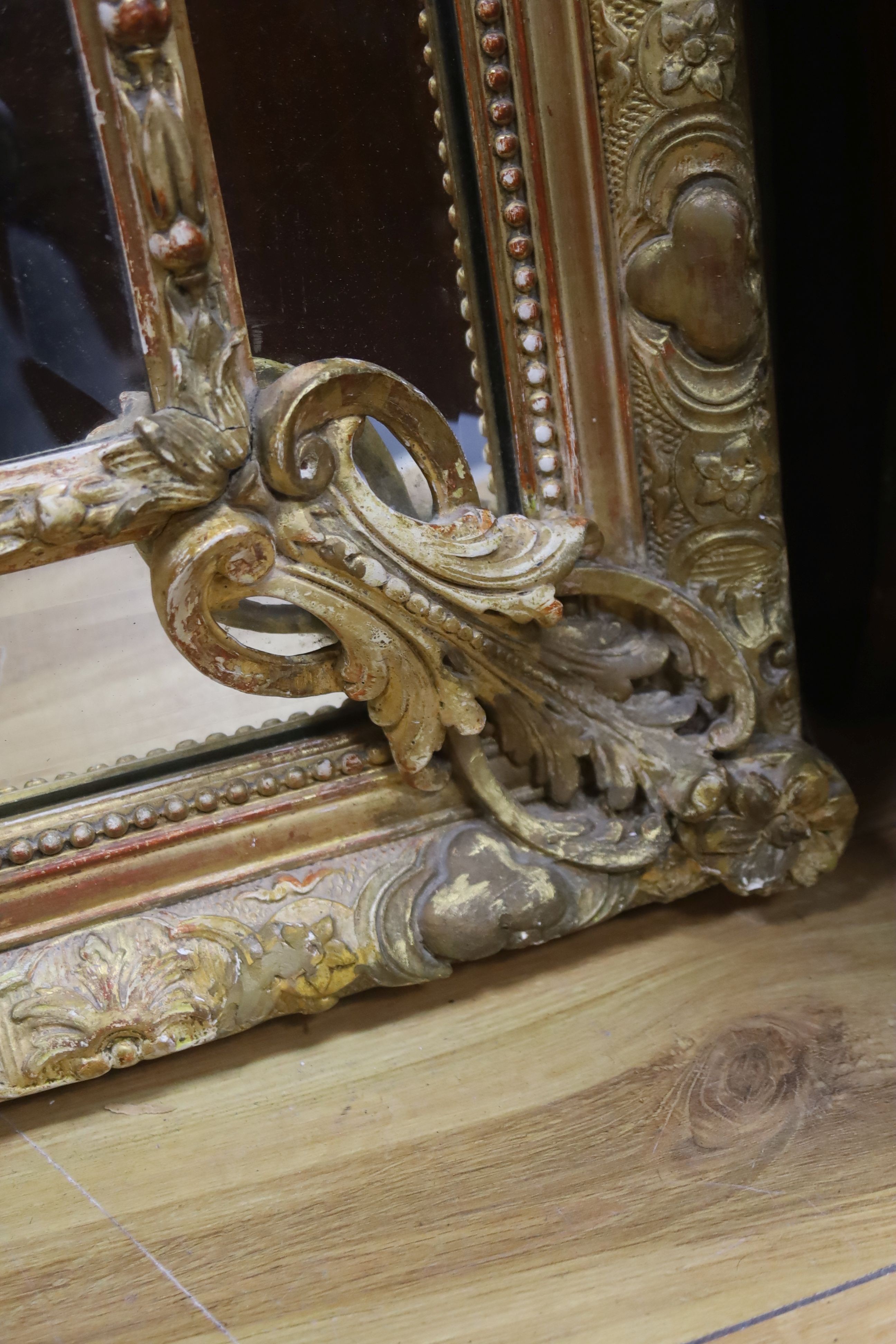 A large 19th century French gilt and gesso frame, bevel edged mirror with cushion margin, plated and C scroll, width 108cm, height 137cm
